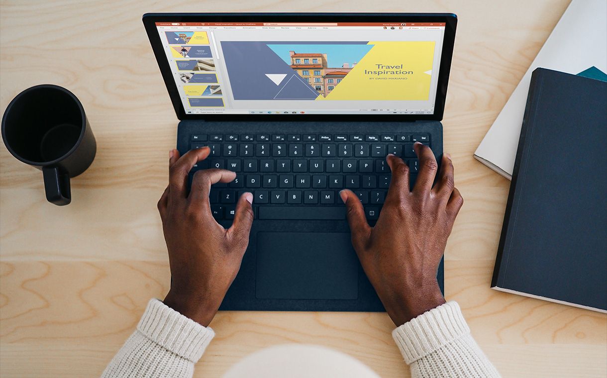 Hands typing on laptop keyboard