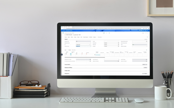 Image of computer on desk displaying the Multi-Entity Management app